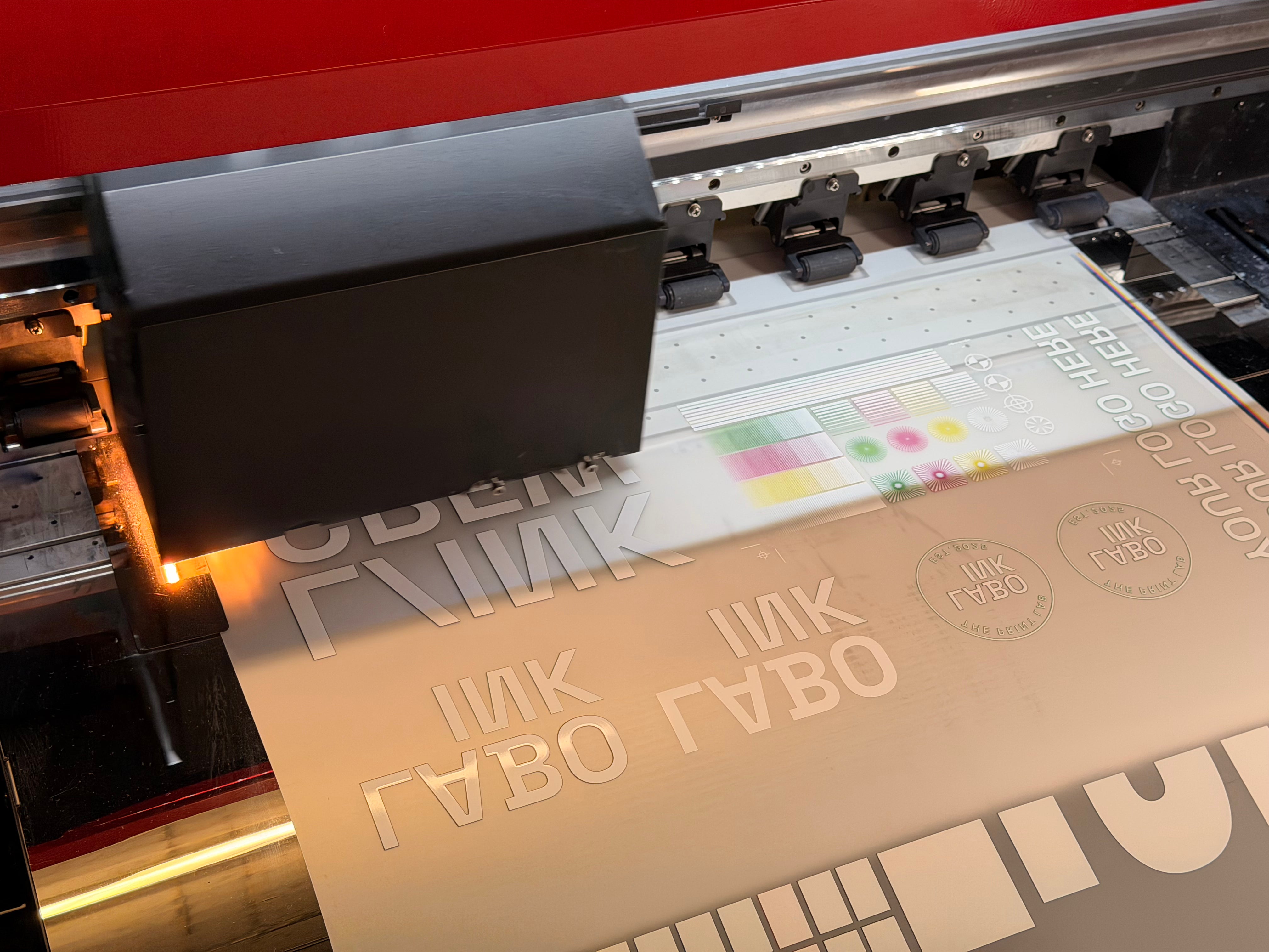 Close-up of a printing process with text and color swatches on DTF Transfer.
